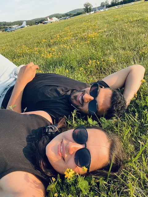 Julia and Nouh relaxing in a meadow