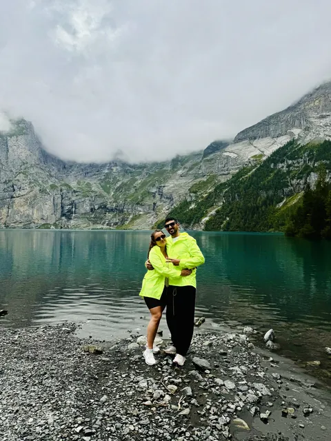 Julia and Nouh beside a mountain lake