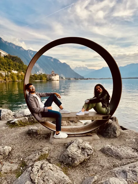 Julia and Nouh sitting by a lake