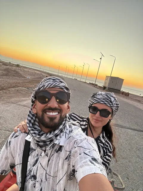 Julia and Nouh in the desert at sunset