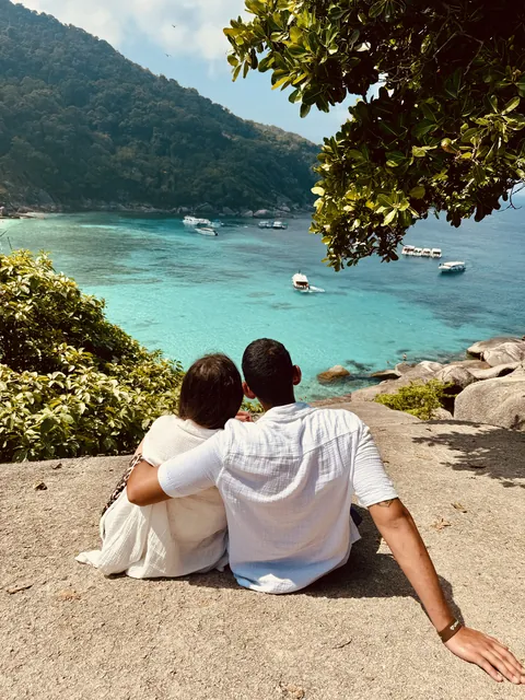 Julia and Nouh overlooking a turquoise bay
