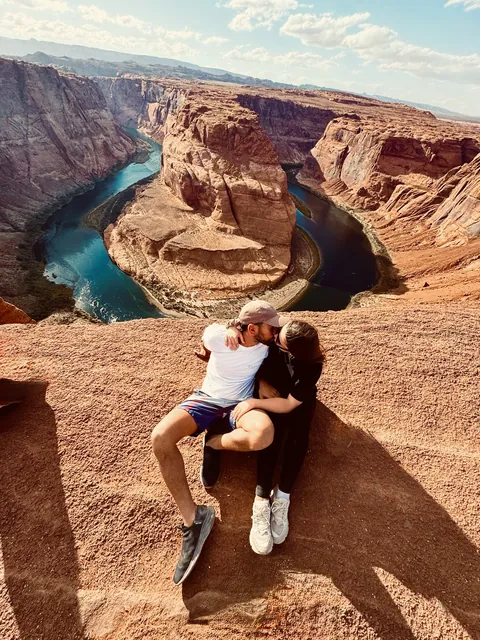 Julia and Nouh overlooking a river canyon