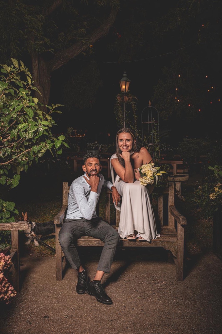 Julia and Nouh sitting together in a garden at night